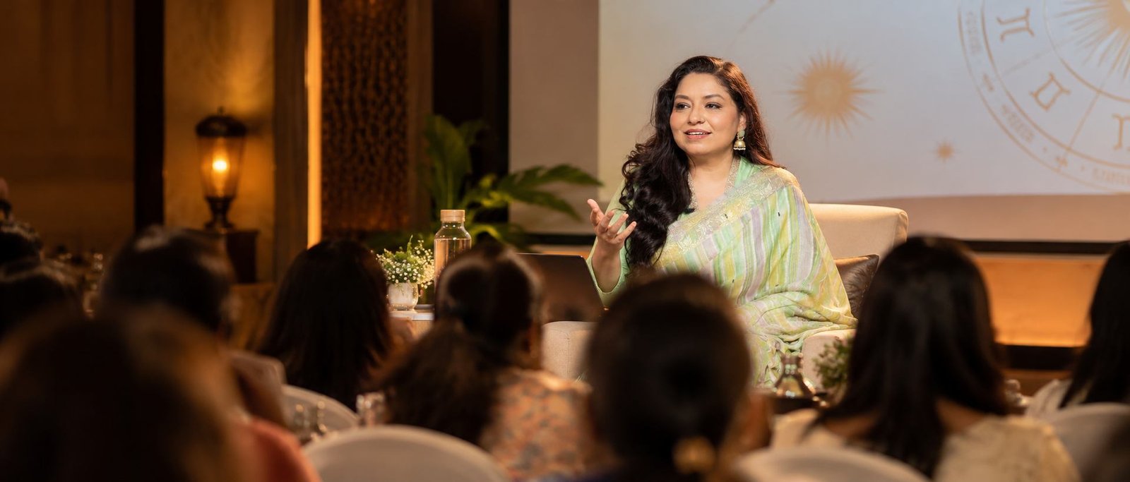 Anita Doval speaking to an audience at an astrology workshop